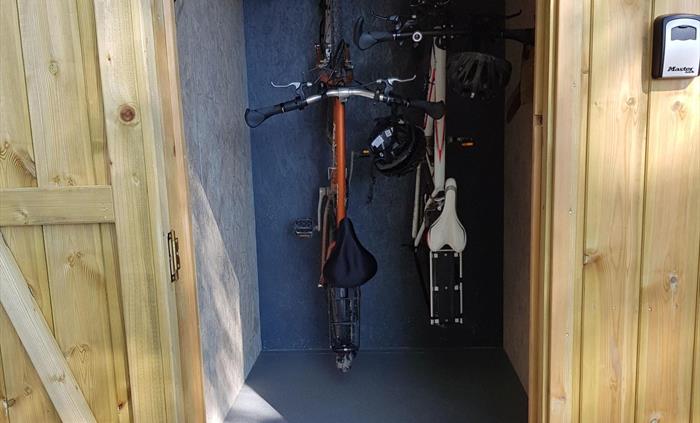 bikes hanging up on hooks in a storage area